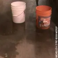 Buckets on the floor at the Castle Sports Club collecting rain from a leaky roof.